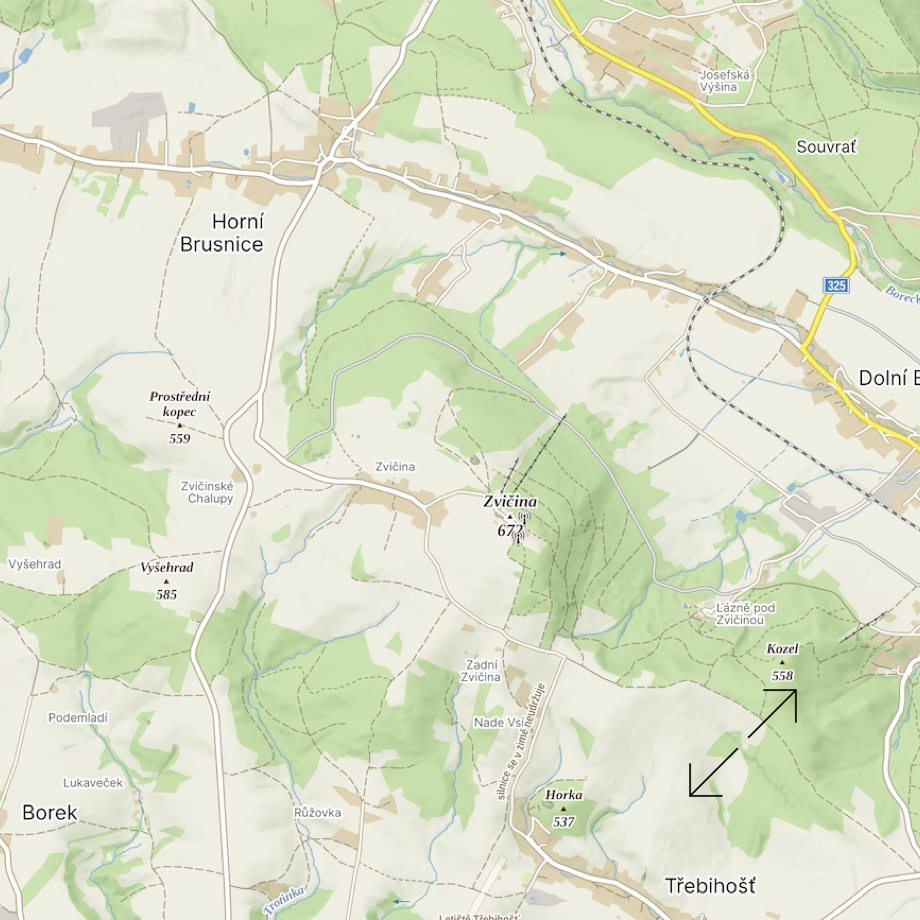 A picturesque A-frame wooden cabin set amidst lush mountains and blue skies.