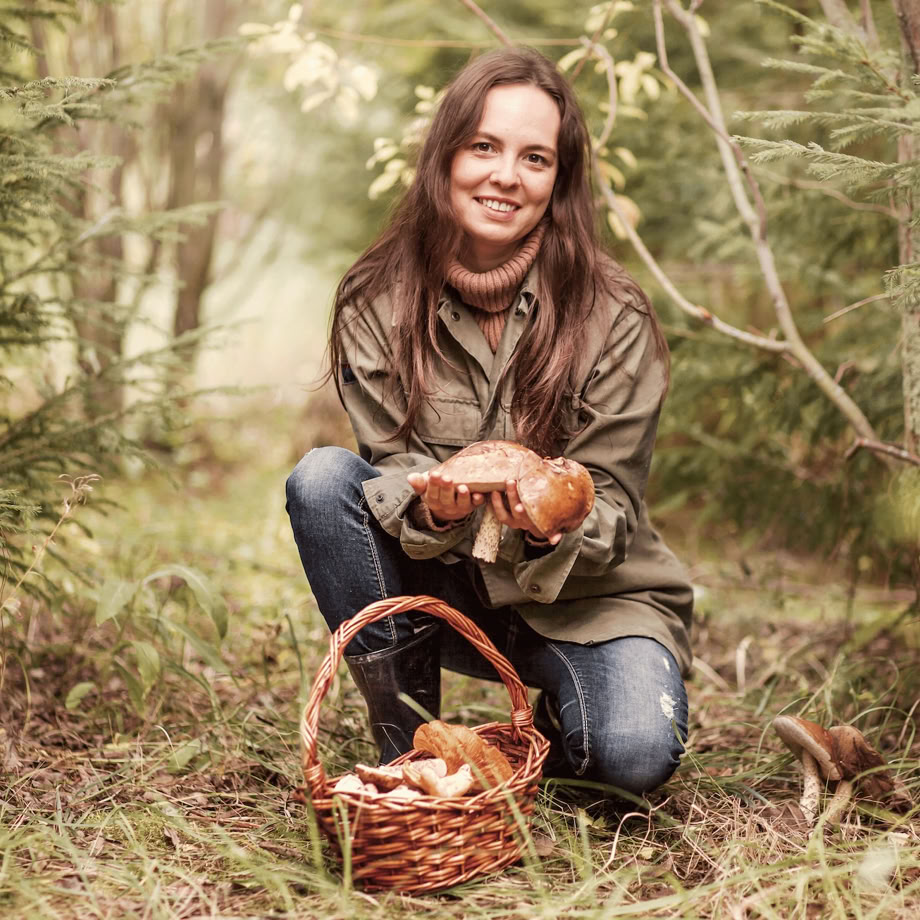 A serene A-frame cabin surrounded by lush greenery under a clear blue sky.